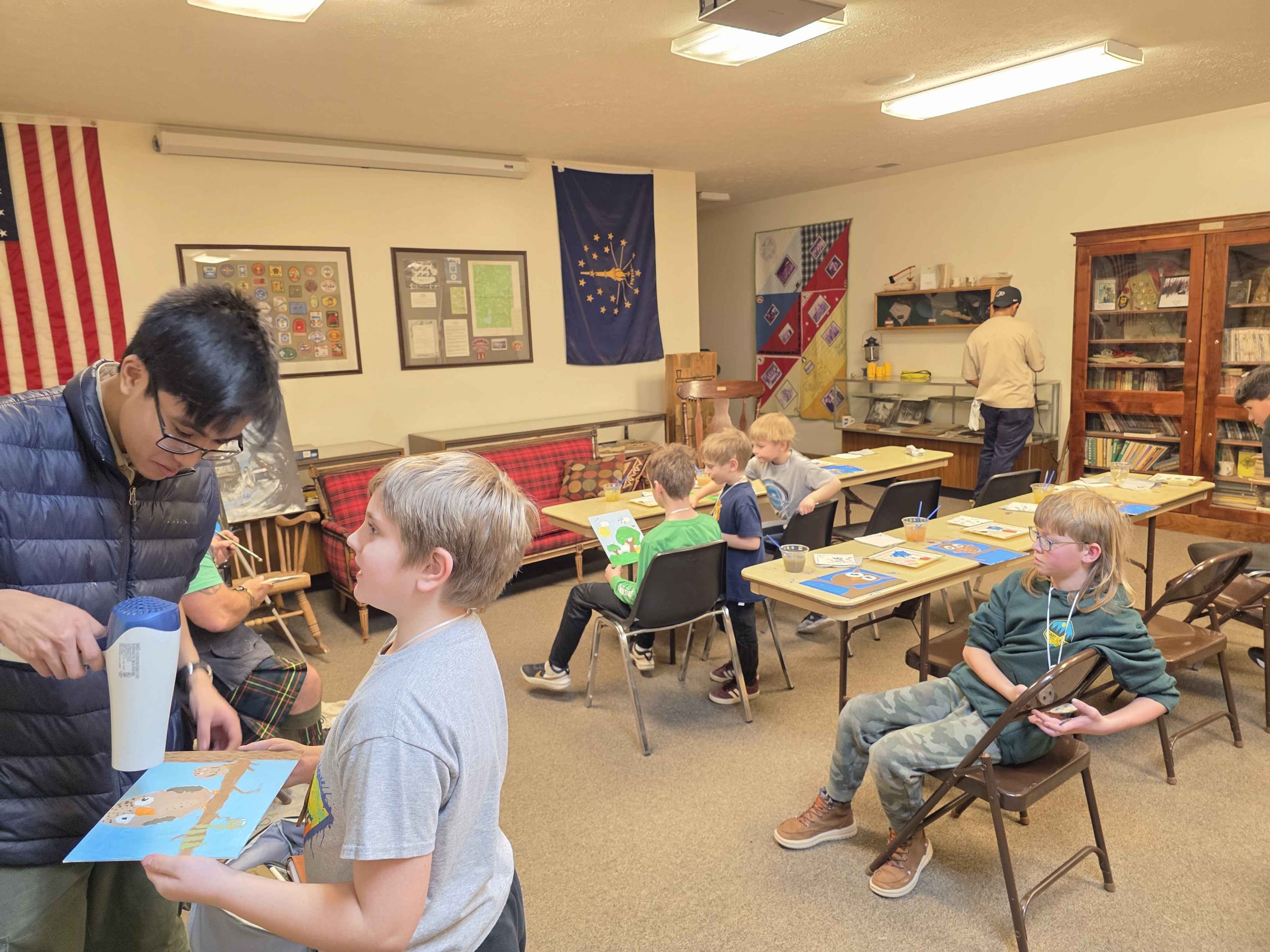 Person helping kid with project