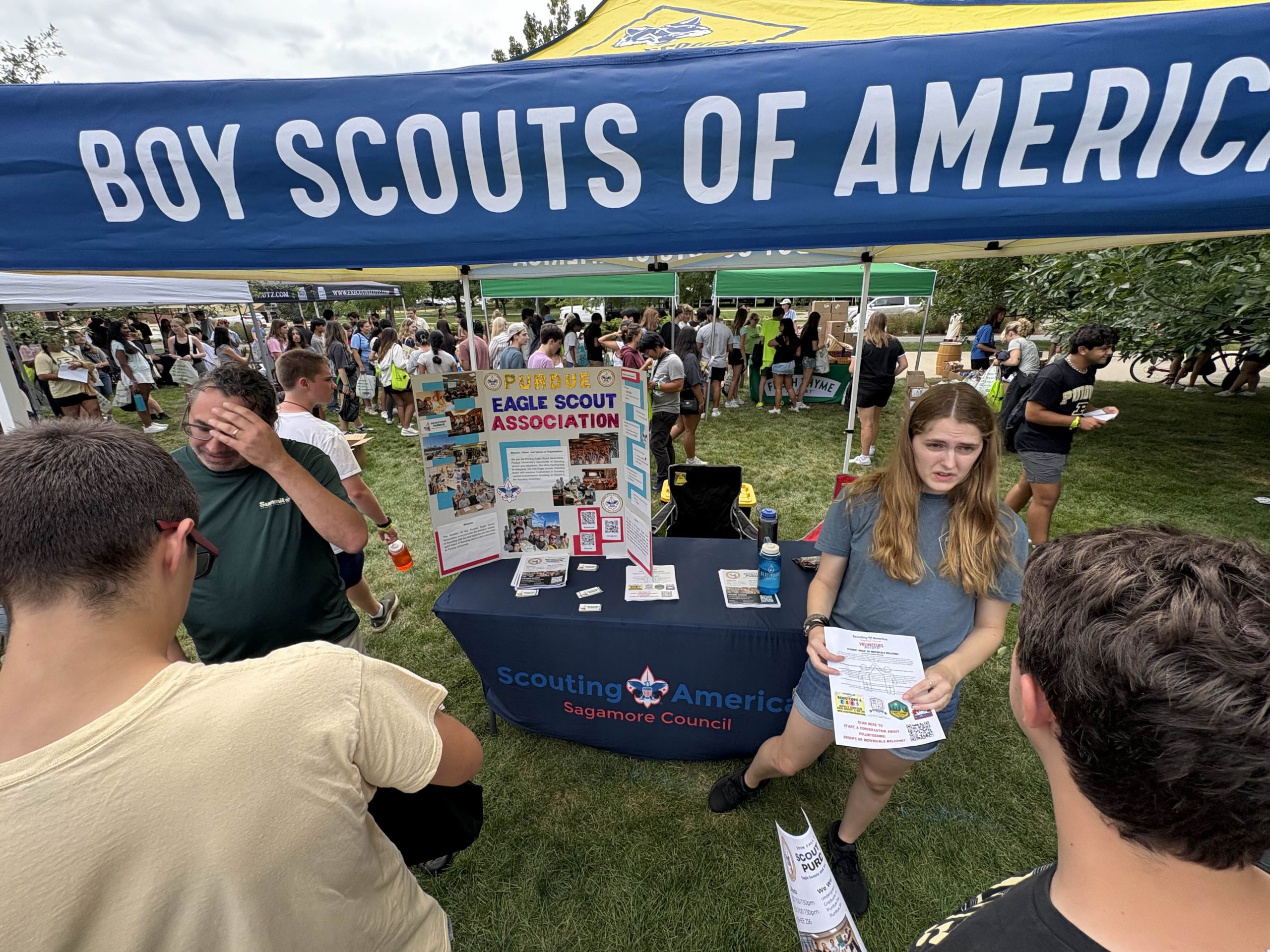 People promoting club at fair